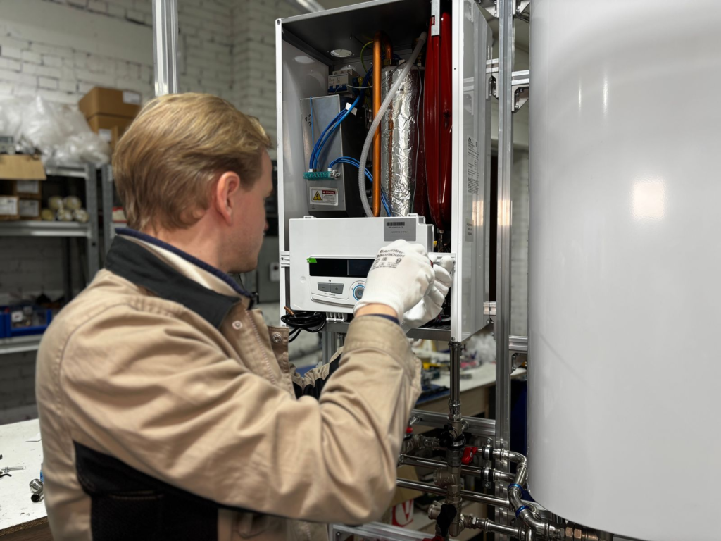 Technician servicing a boiler heating unit